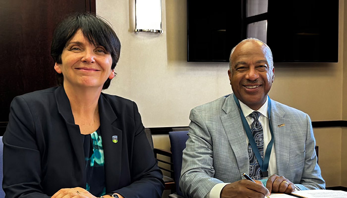 University College Dublin Professor Orla Feely and UC Davis Professor Gary S. May signing agreement